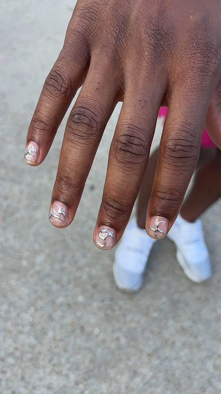 Short nude nails with raised silver abstract designs